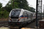 Commuter shoves out of the station behind a pair of locos